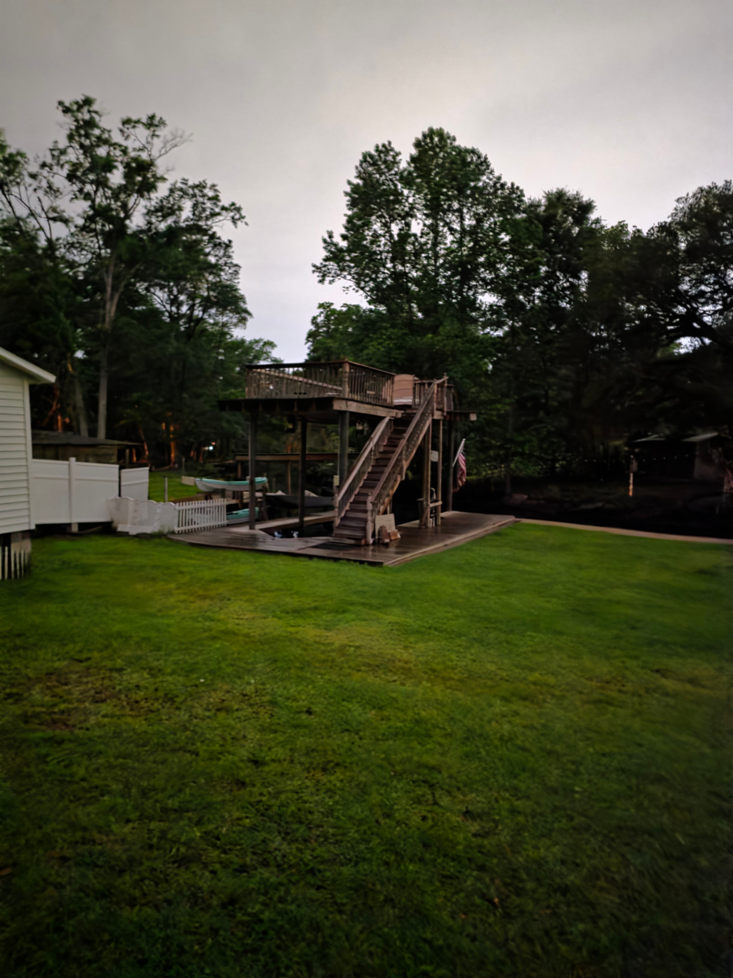 Overgrown waterfront yard and dock area before restoration