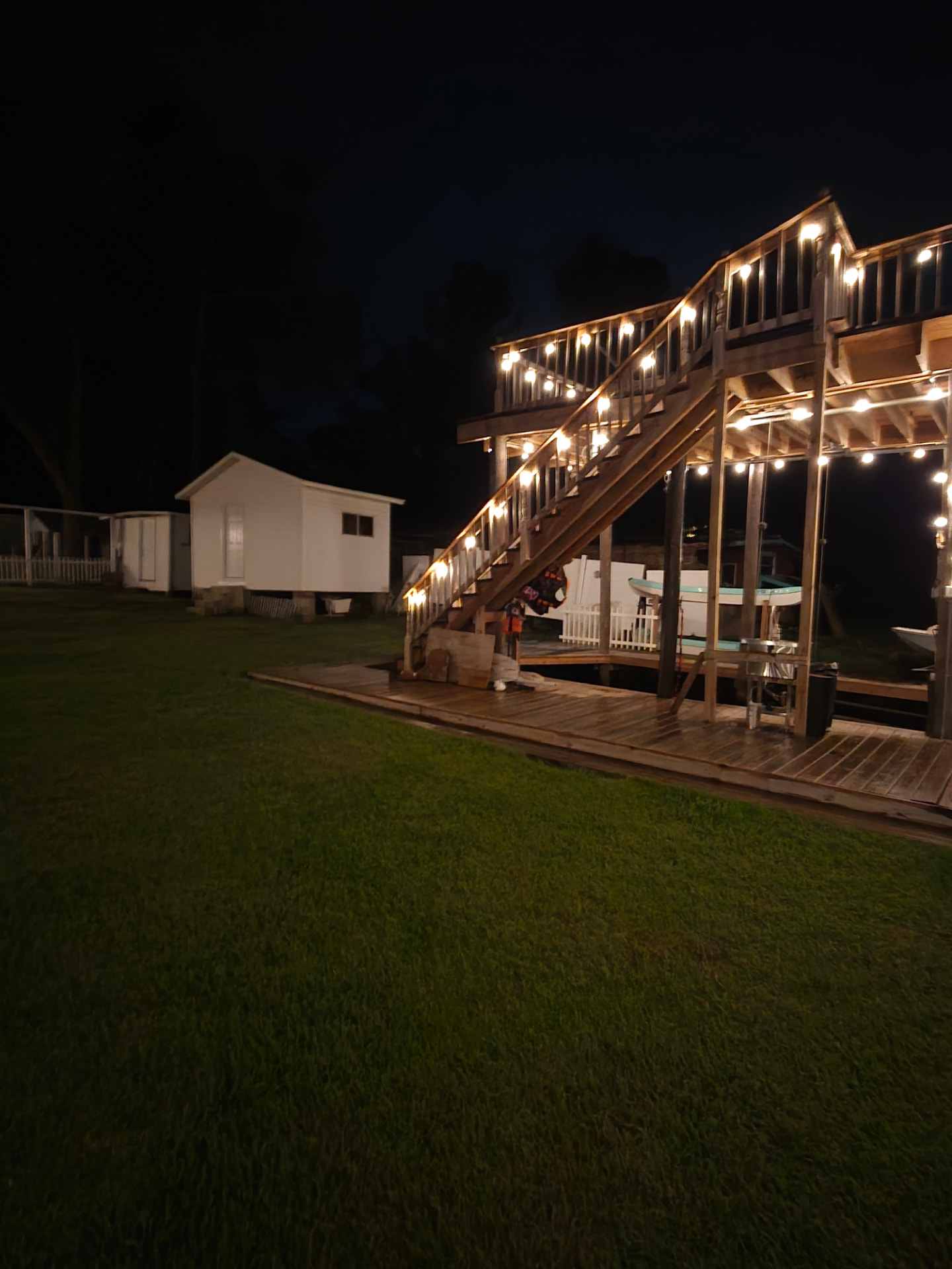 Two-story dock and deck lit at night