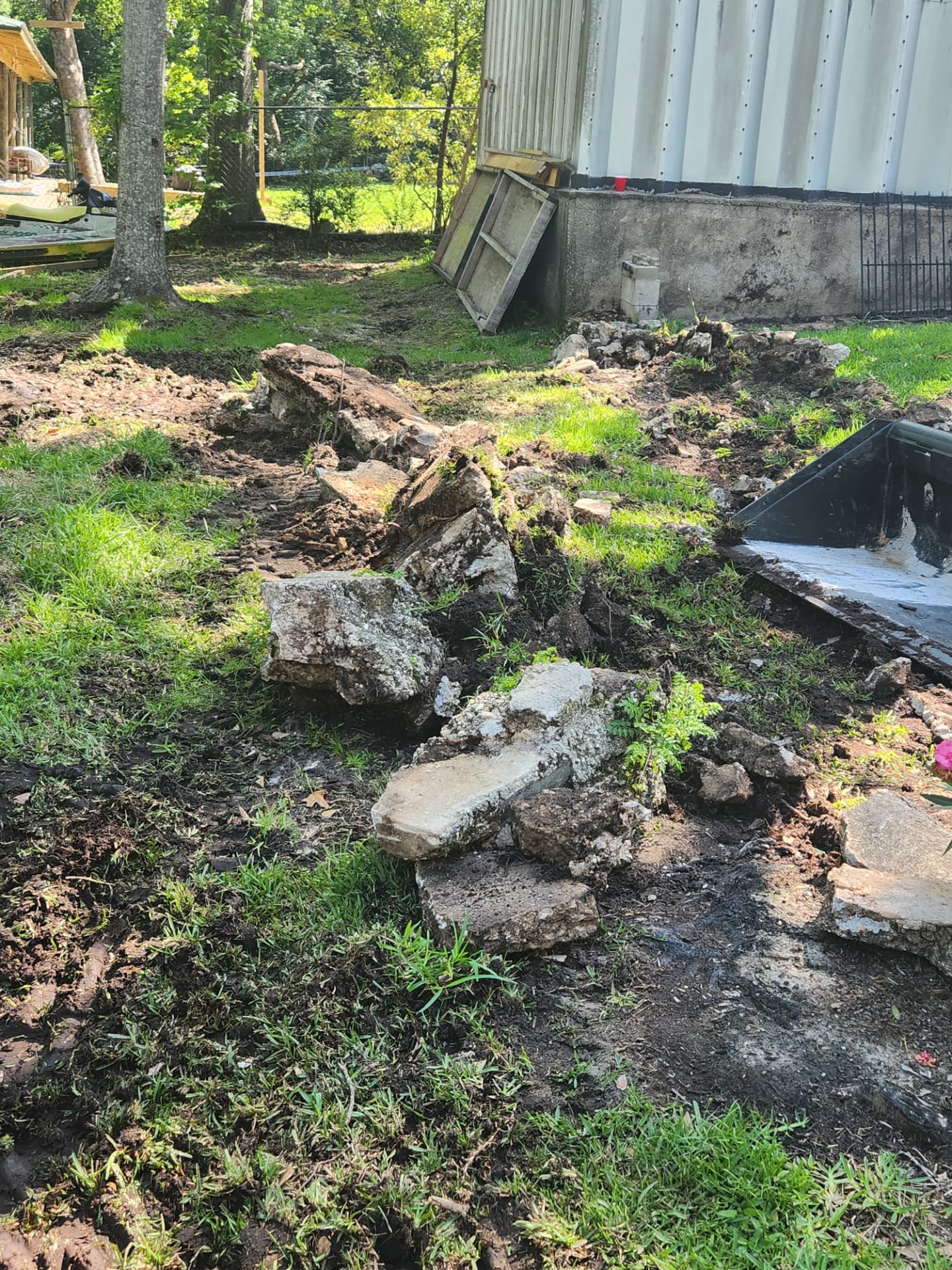 Piles of broken concrete slabs staged for removal