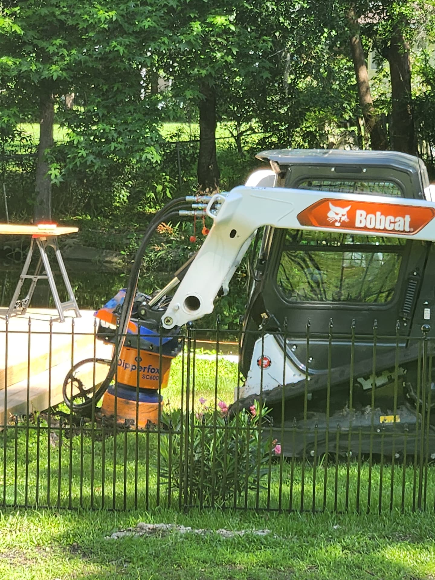 Profile view of the Bobcat with stump grinder attached