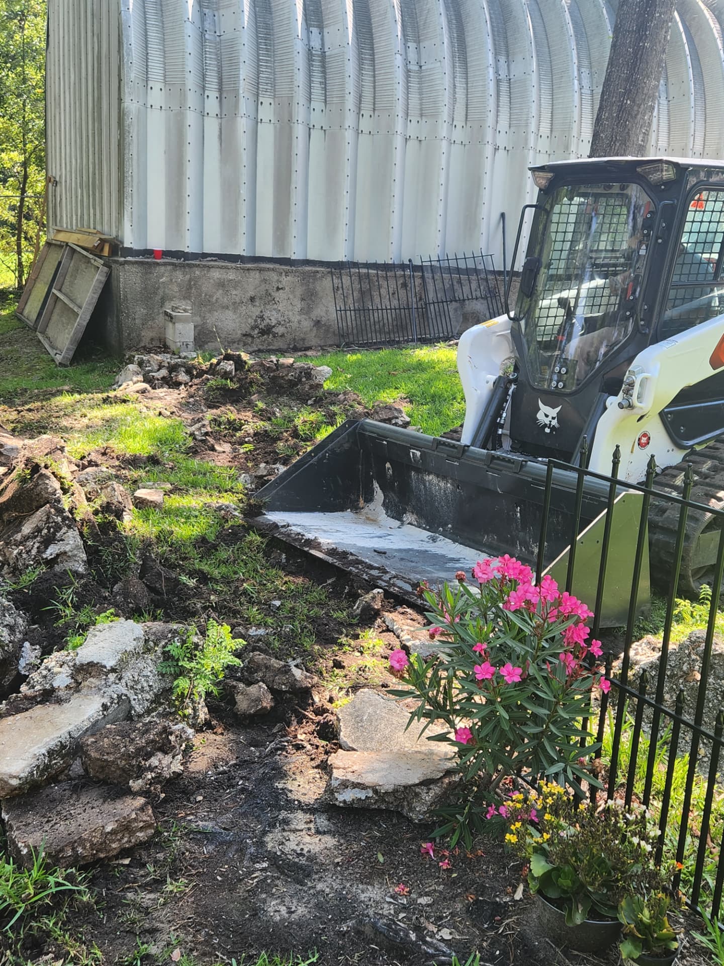 Loader bucket picking up concrete demo waste